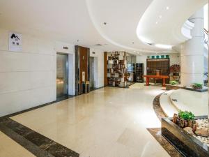 a lobby of a building with a desk in it at Poly Hotel in Guangzhou +259 photos