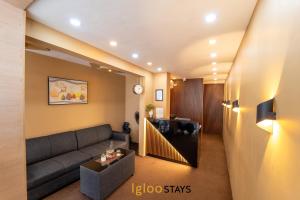 a living room with a couch and a table at Igloo Stays Kakkanad in Kakkanad