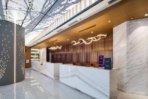 a lobby of a store with a reception counter at Mercure Xi'an Daming Palace in Xi'an