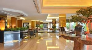 a lobby of a hotel with tables and chairs at The Axana Hotel in Kampungdurian +141 photos