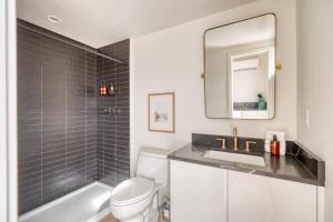 a bathroom with a toilet and a sink and a mirror at Stay Portland - Alberta Arts-tastic Mother-In-Law Suite in Portland