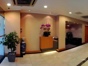 a lobby with flowers on the wall in a building at Goodrich Hotel in Hong Kong