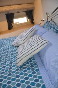 En eller flere senge i et værelse på A Casa di Nonna Linda B&B