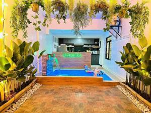 een zwembad in het midden van een kamer met planten bij Entire 2BR Private Villa eith Indoor Pool & BBQ Grill in Sampong