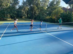 a group of people playing tennis on a tennis court at Almási Öregmalom in Dunaalmás +26 photos