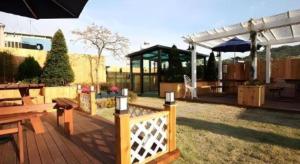 a wooden deck with a picnic table and a pavilion at Myeongdong Mom House in Seoul