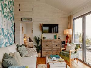 a living room with a couch and a tv at 2 Bed in Whitsand Bay 91328 in Antony