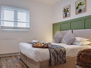a bedroom with a bed with a basket of fruit on it at 1 Bed in Newport 95453 in Newport