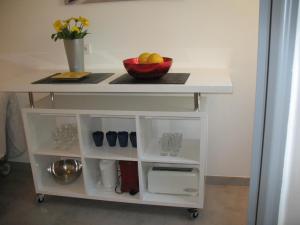 a white cart with a bowl of fruit on it at Studio du Lac in Cannes