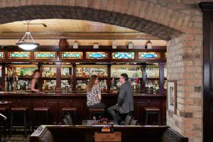 a man and a woman standing at a bar at Central Loop Hotel in Chicago