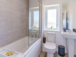 a bathroom with a tub and a toilet and a sink at 2 Bed in St Davids 82312 in St. Davids +20 photos