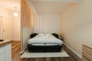 a small bedroom with a bed in the corner at Le Velours in Valence