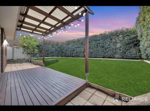 an outdoor patio with a lawn with a pergola at Green and sereen home in western suburbs in Truganina