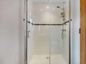 a shower with a glass door in a bathroom at 3 Bed in Swanage 94067 in Swanage +12 photos