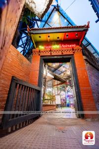 una entrada a un edificio con una puerta abierta en Muglan Hotel and Restaurant Bhaktapur, en Bhaktapur