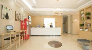 a lobby with two men standing at a counter at GreenTree Inn Changzhou Wujin Bus Station in Changzhou