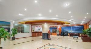 a large room with a lobby with a lobby at GreenTree Inn Yantai Xingfu Road Marina Plaza Express Hotel in Yantai