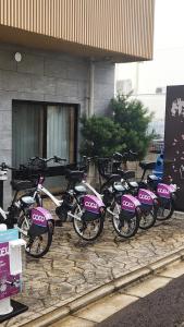 a row of pink motorcycles parked in front of a building at Stay SAKURA Kyoto Tambaguchi in Kyoto