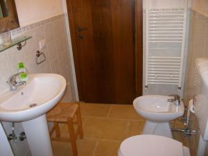 a bathroom with a sink and a toilet at Masseria Lacco in Muro Leccese