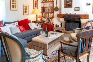a living room with a couch and a fireplace at Gîte Les Ailliers in La Chaudière
