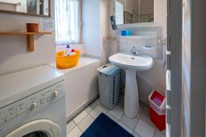 a small bathroom with a sink and a toilet at Gîte Les Ailliers in La Chaudière +22 photos