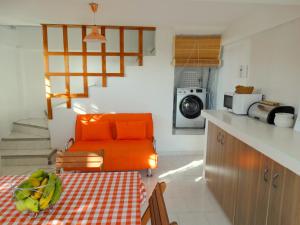 an orange chair in a kitchen with a table at Blue Appartment in La Gaulette