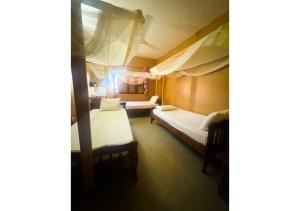 a room with two beds in a room at Flamingo Guest House in Zanzibar City