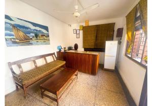 a living room with a couch and a refrigerator at Flamingo Guest House in Zanzibar City +23 photos