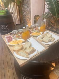 ein Tisch voller verschiedener Brotsorten und Säfte in der Unterkunft La Posada de Botavara in Madrid