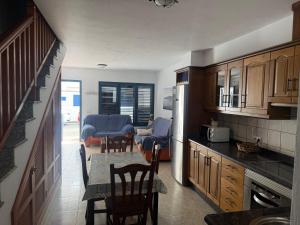 a kitchen with a table and chairs and a dining room at Casa La Charca De Famara in Famara