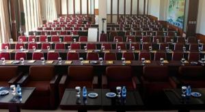 a large auditorium with red chairs and tables in a room at Jimmers Mountain Resort in Puncak +135 photos