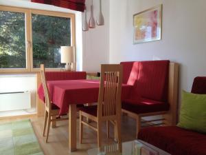 a dining room with a red table and chairs at Ferienwohnung Marion in Hermagor