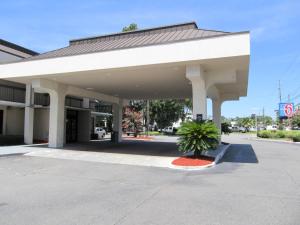 a large white building with a sign on the side of it at Motel 6-Savannah, GA - Midtown in Savannah