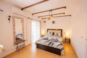 a bedroom with a bed and a desk and a mirror at Sweet Home Botanico in Adeje +54 photos