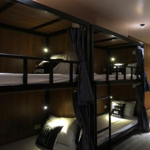 a room with three bunk beds in a room at Hanoi Dormiam - Wonderful Sightseeing of West Lake in Hanoi