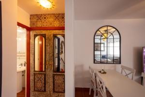 a dining room with a table and a mirror at Sweet Home Botanico in Adeje +93 photos
