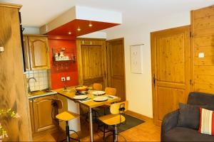a kitchen with a table and chairs in a room at Alpine Cocoon at 5 min On foot from the cable car in Les Houches