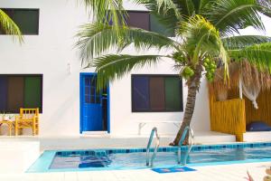 a palm tree next to a swimming pool at Lanta Secret House in Ko Lanta