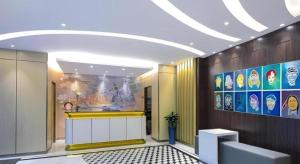 a lobby with a yellow counter in a building at Magnotel Shanghai Maglev Station in Shanghai