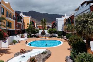 a large swimming pool in the middle of a city at Sweet Home Botanico in Adeje