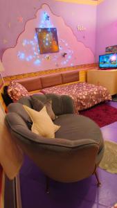 a living room with a chair and a bed at Pension Relax in Litoměřice +66 photos