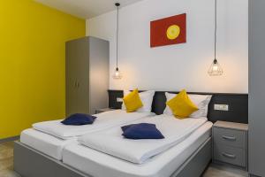 two beds in a room with yellow walls at Johann Strauss Hotel in Bucharest +66 photos