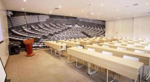 a lecture hall with rows of chairs and a podium at ibis Xi'an First Gaoxin RD in Xi'an