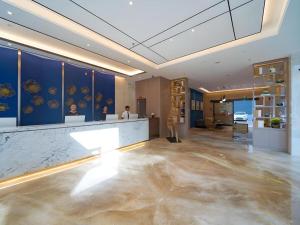a large lobby with a marble counter and blue walls at GreenTree Eastern Dali Railway Station Hotel in Dali