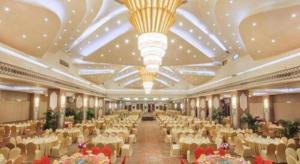 a large banquet hall with white tables and chairs at Cinese Hotel Dongguan in Dongguan