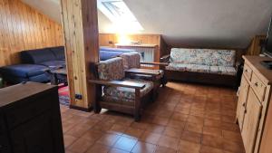 a living room with a couch and a chair at Mansarda in Morgex