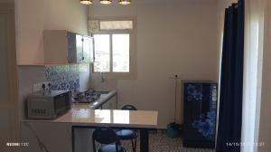 a kitchen with a counter top and a microwave at Country View Cottage Colva in Colva