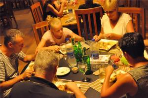 a group of people sitting around a table eating food at Kottawatta Village in Udawalawe