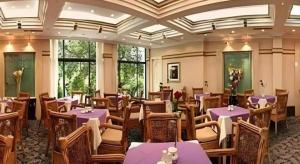 a restaurant with purple tables and chairs and windows at Chengde Yunshan Hotel in Chengde