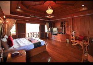 a bedroom with a large bed in a room at Ngamta Hotel in Mae Hong Son +177 photos